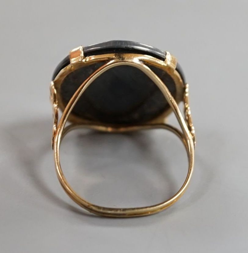 A yellow metal and facet cut hematite dress ring, size Q/R, gross weight 7.1 grams.